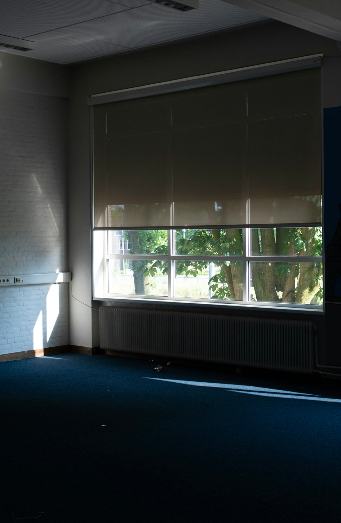a room with a large window and a radiator
