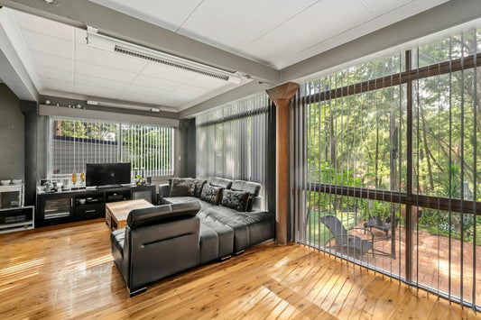 A living room filled with furniture and lots of windows